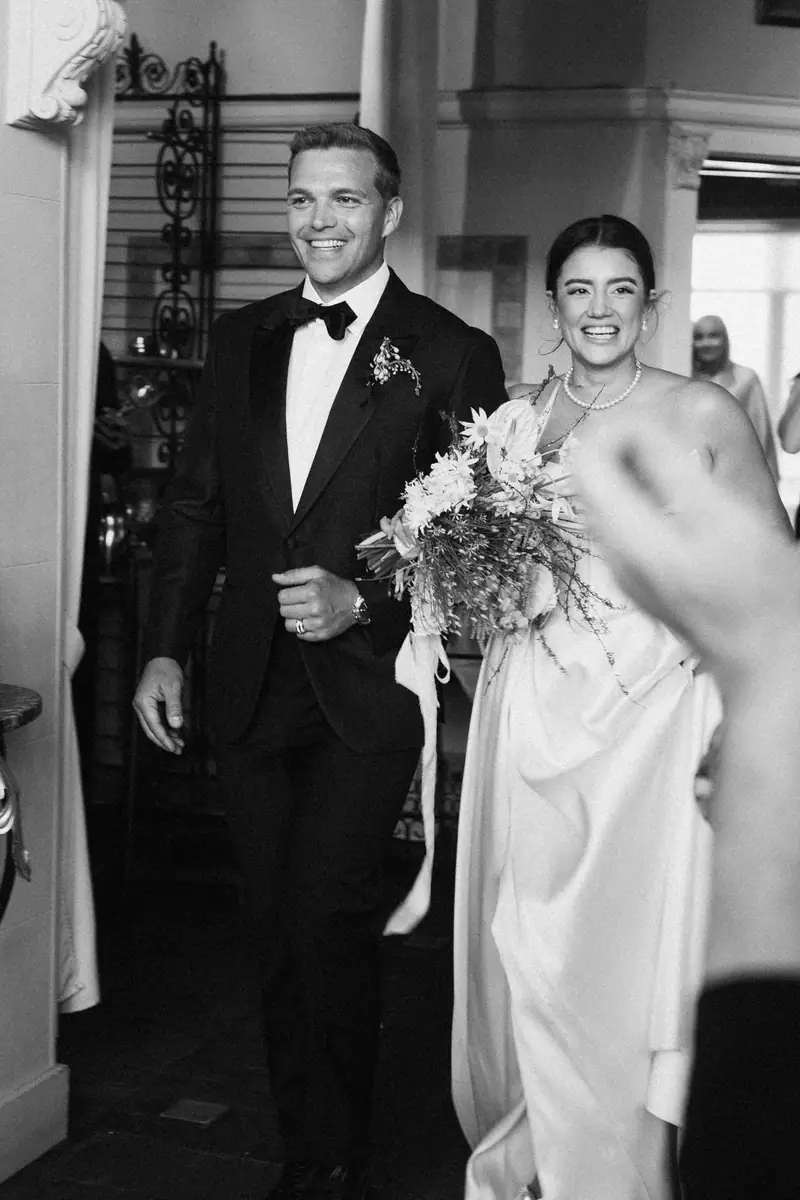 Black-and-white photo of a smiling bride and groom
